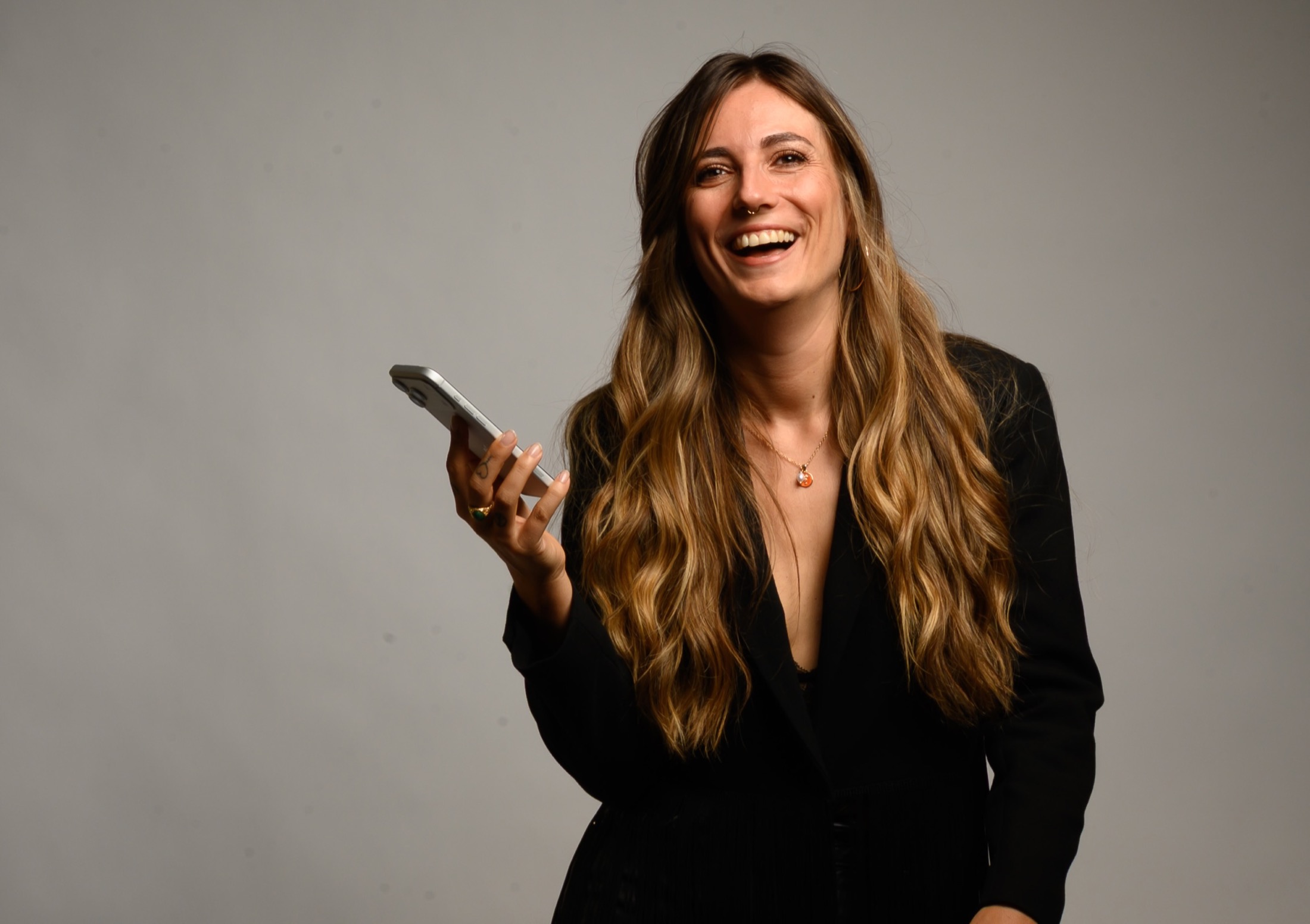 Maria Kreutzer holding her phone and smiling